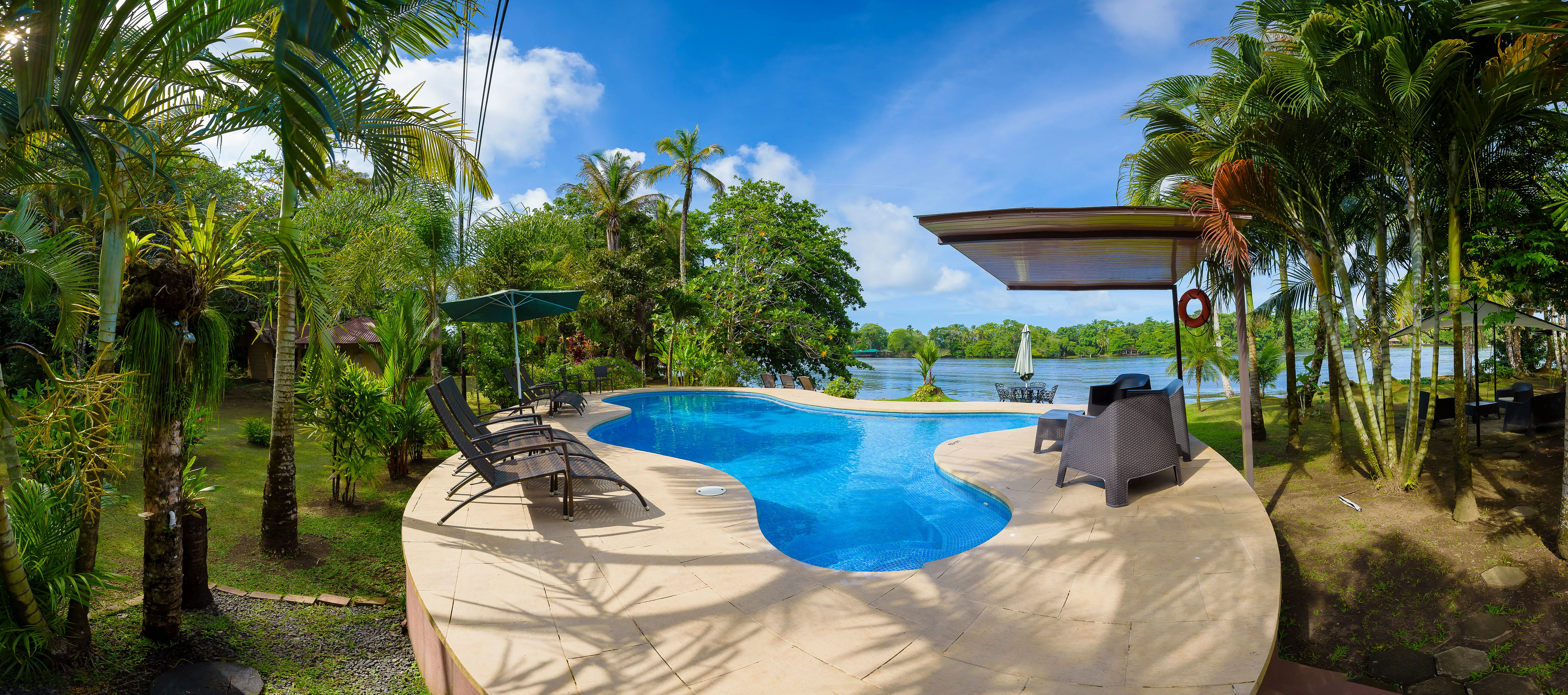 Pool area and river view at Manatus